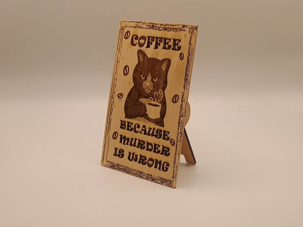 Small wooden sign with a cat holding a coffee with text