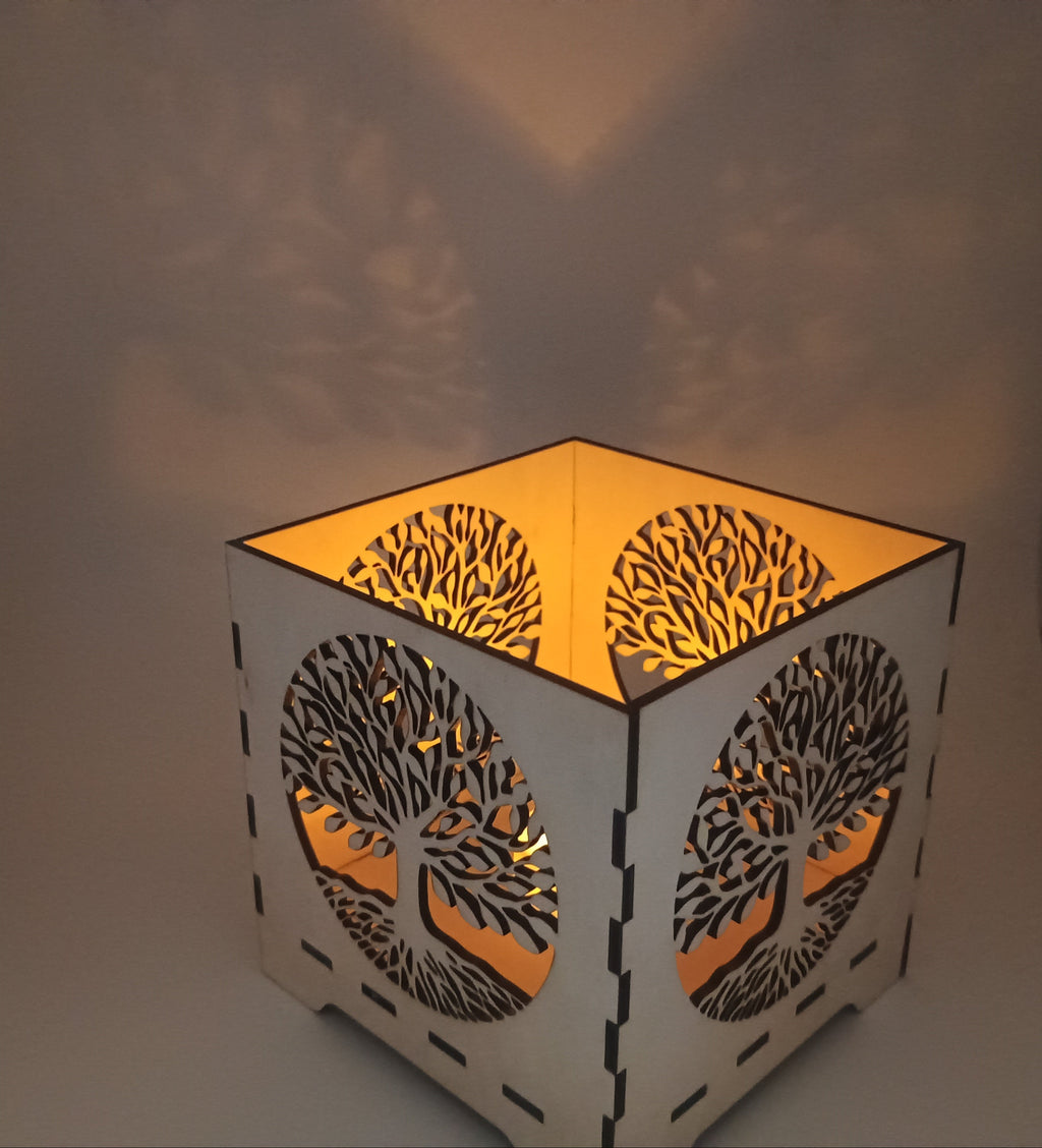 Decorative lamp with tree-of-life design on a plain background
