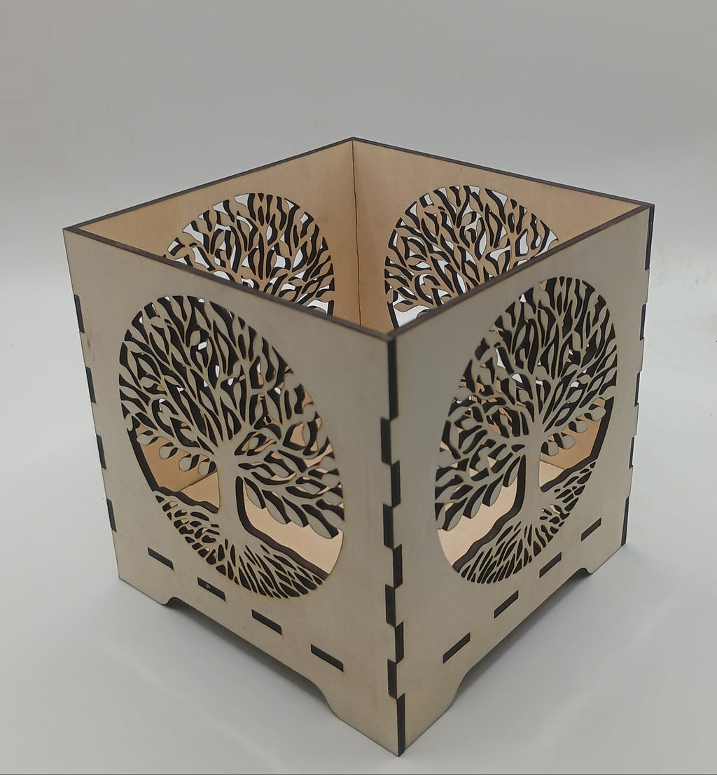 Decorative lamp with tree-of-life design on a plain background