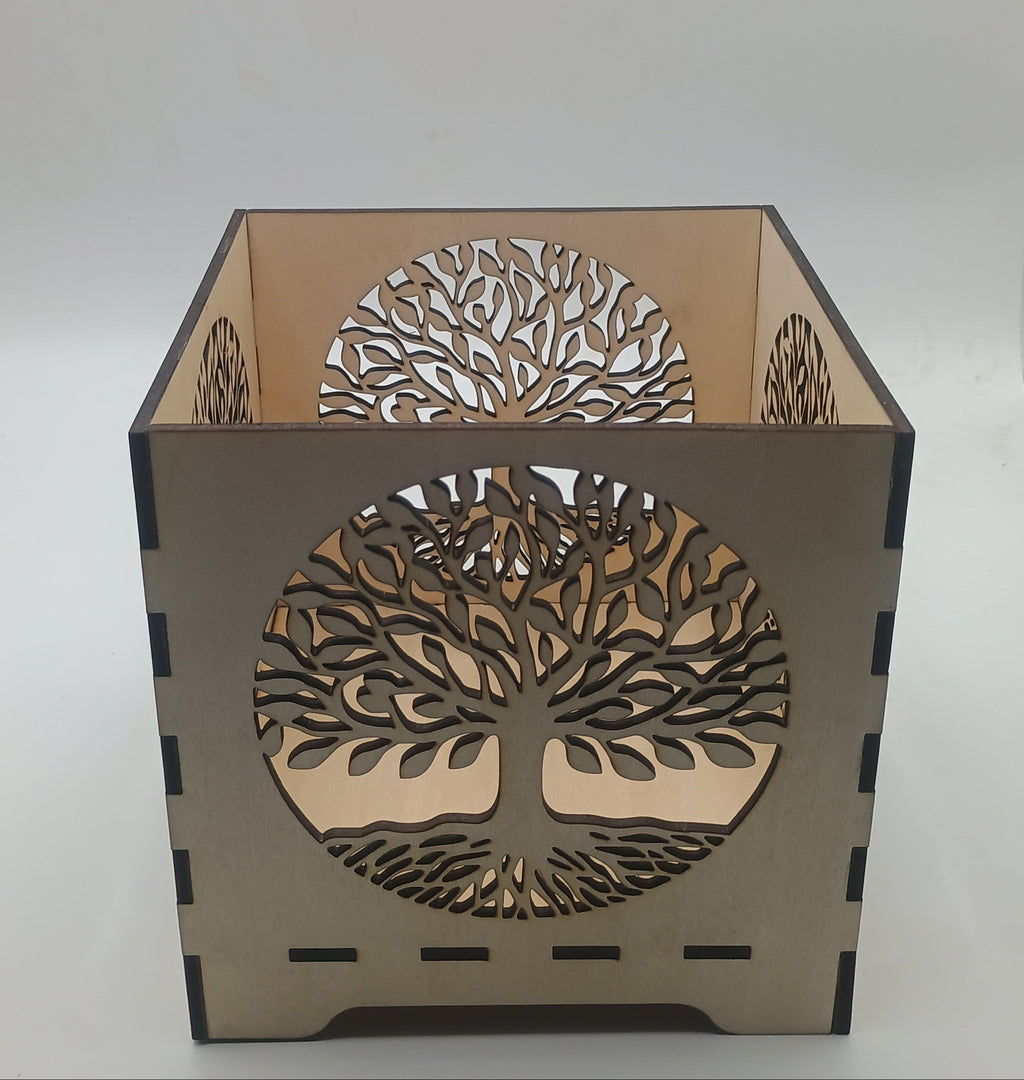 Decorative lamp with tree-of-life design on a plain background