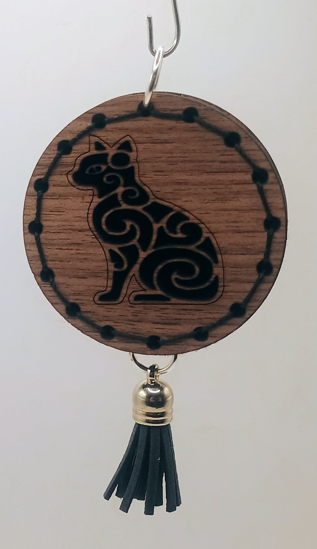 Decorative hanging item with a cat design on a plain background