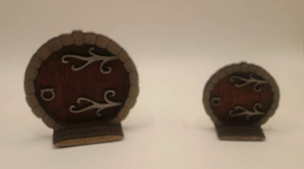 Two small wooden doors with metal hinges and handles on a white background