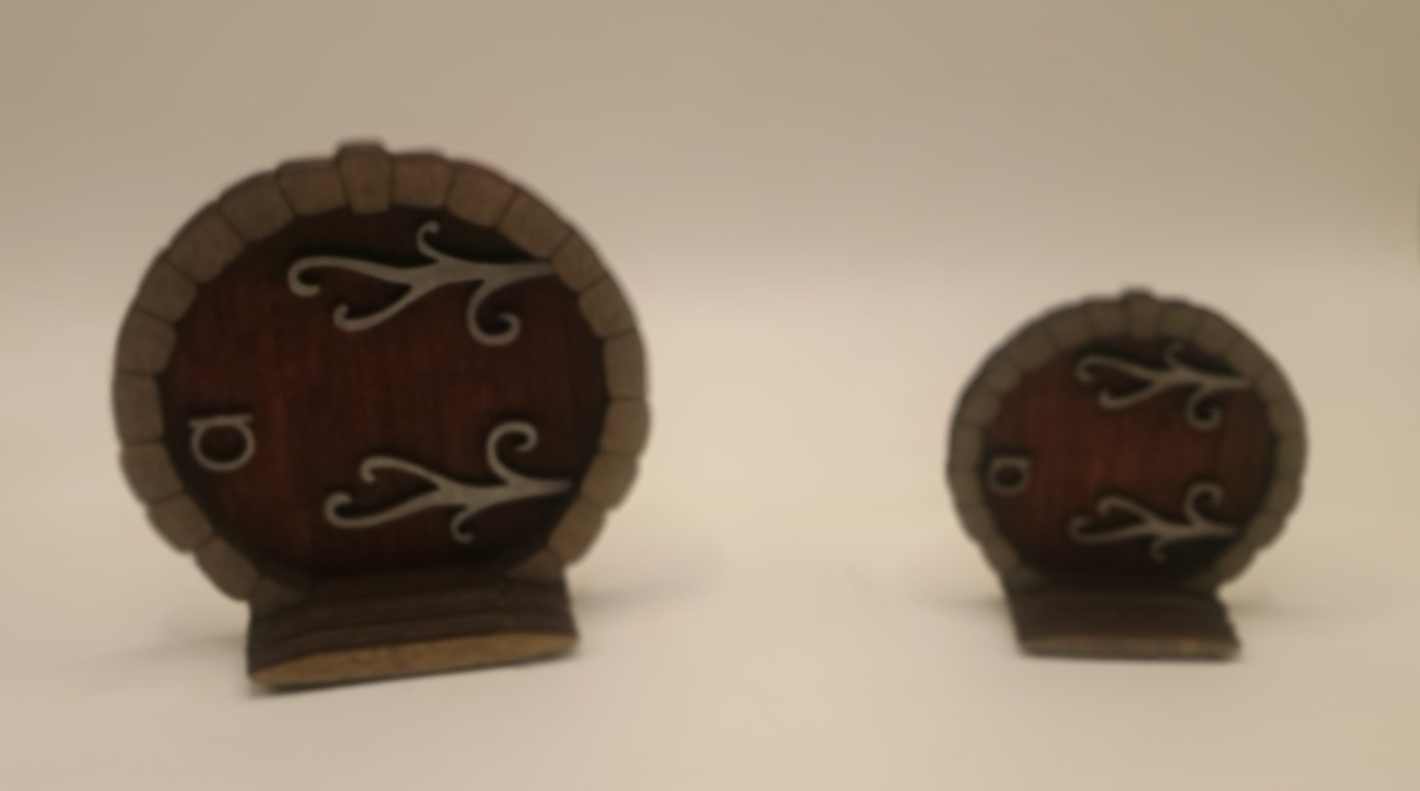 Two small wooden doors with metal hinges and handles on a white background