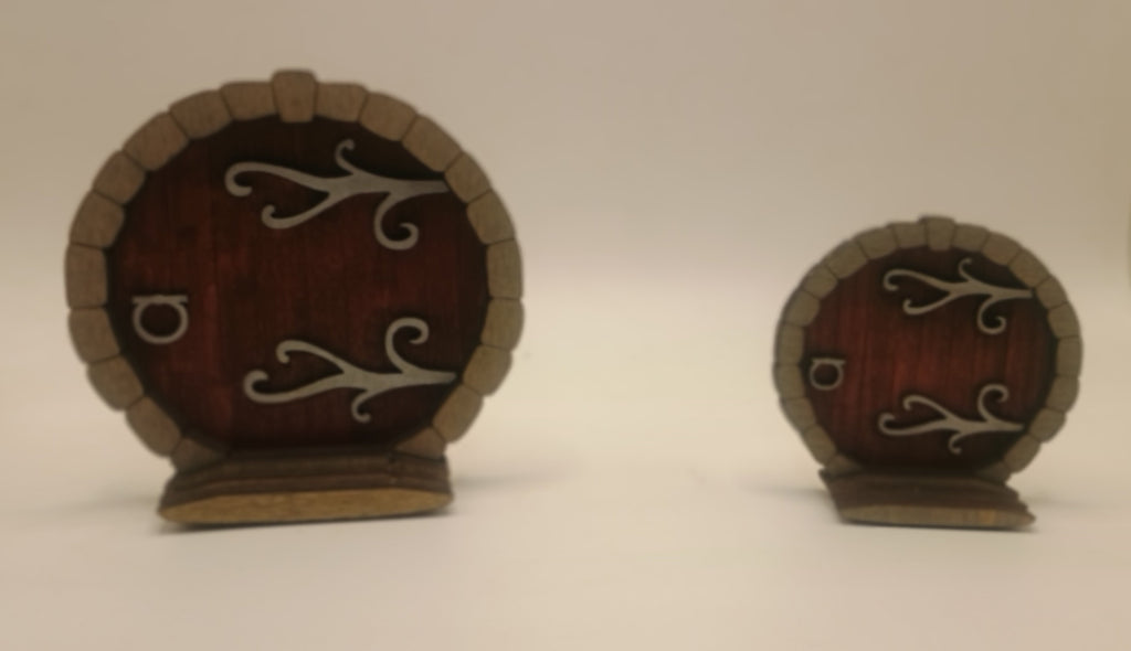 Two small wooden doors with metal hinges and handles on a white background