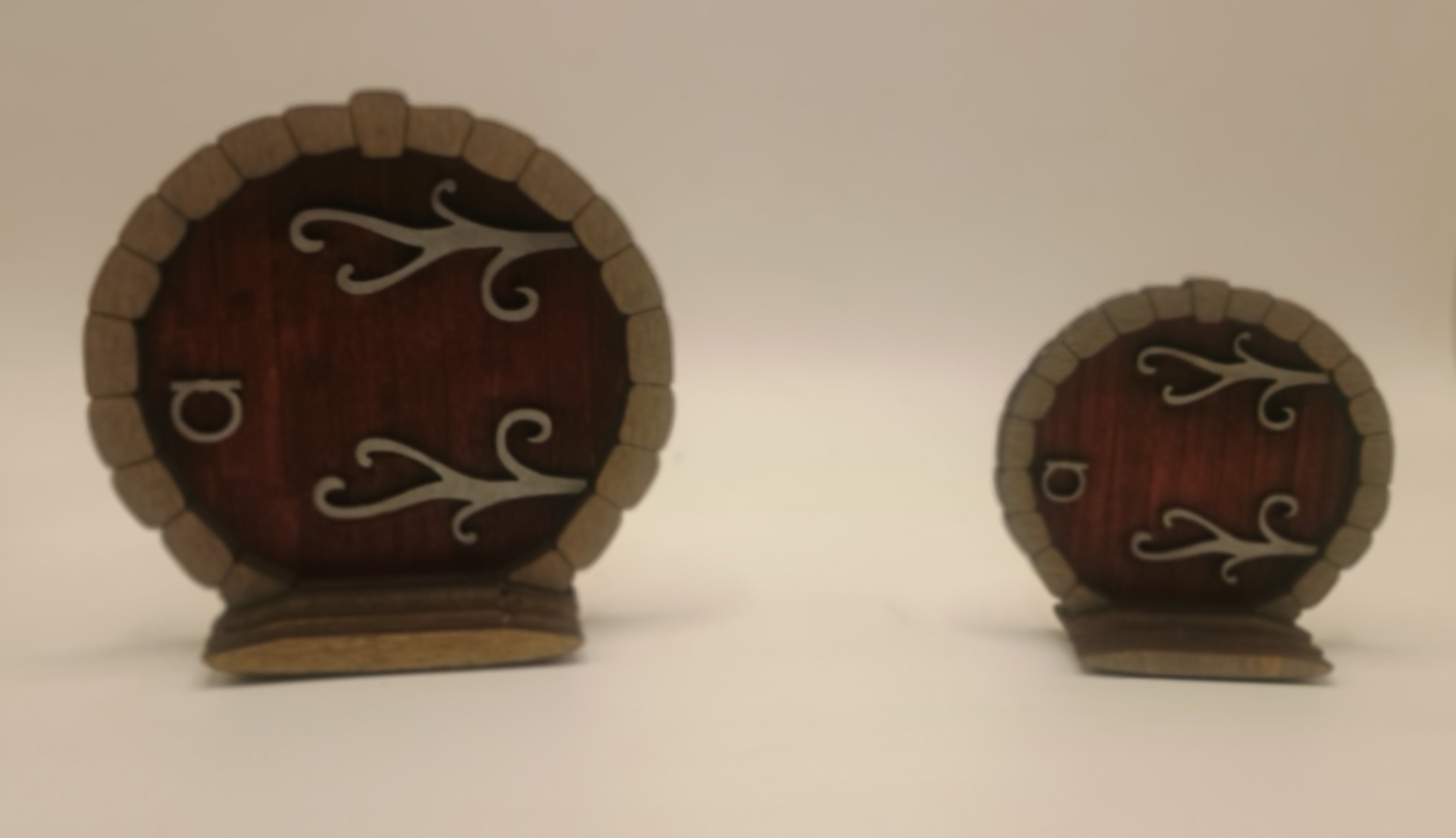 Two small wooden doors with metal hinges and handles on a white background