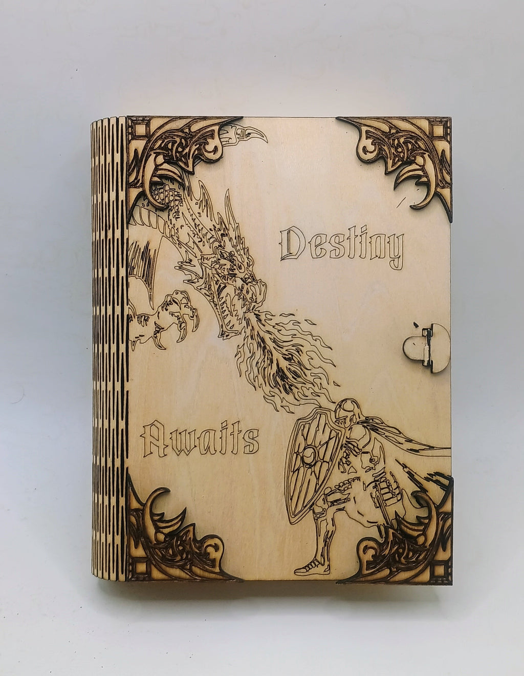 A small wooden book-style storage box with engraved fantasy artwork and the words 'Destiny Awaits' on the front.