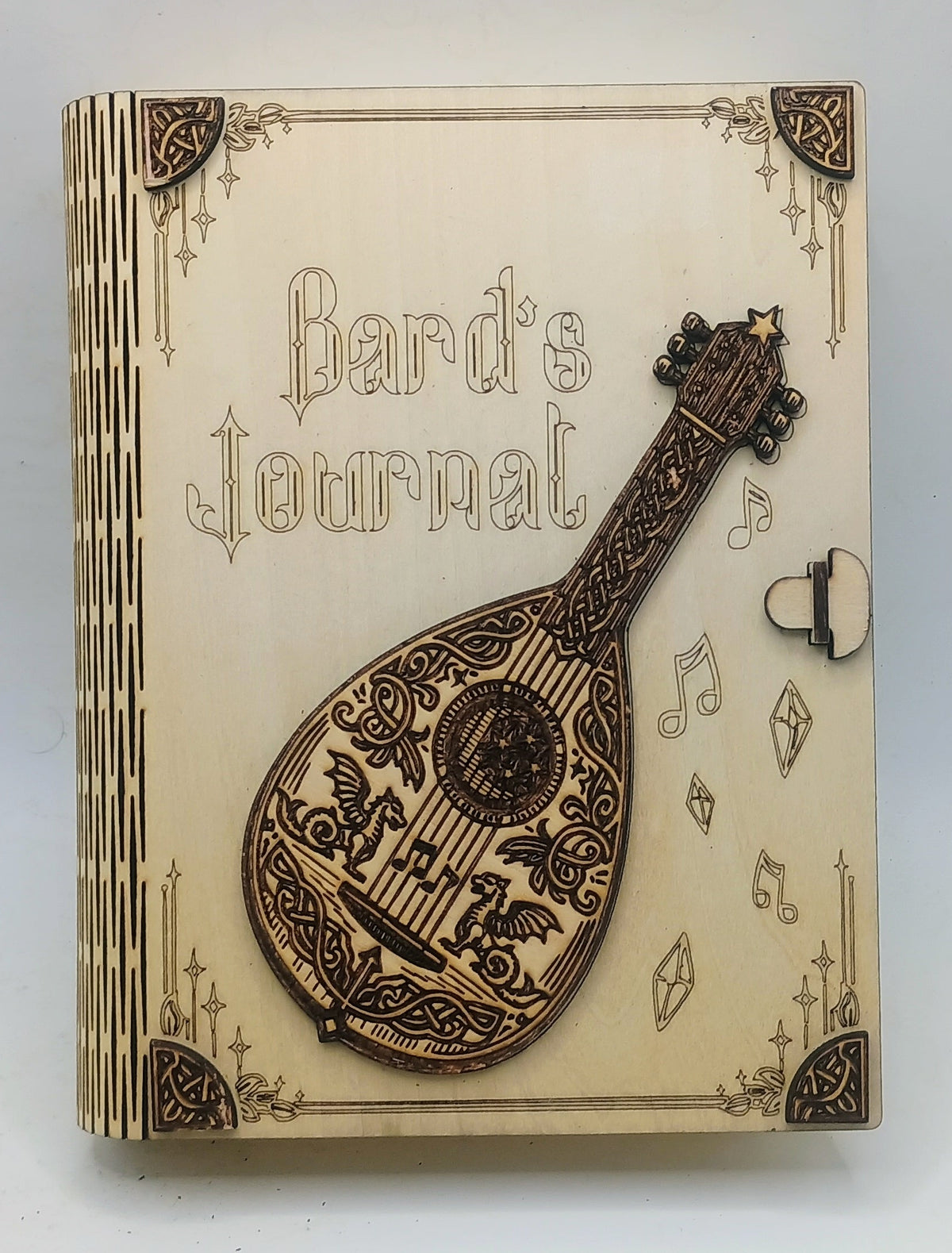 A wooden box titled 'Bard's Journal' featuring a laser-engraved mandolin on the front cover.