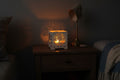 Decorative lamp with tree-of-life design on a plain background